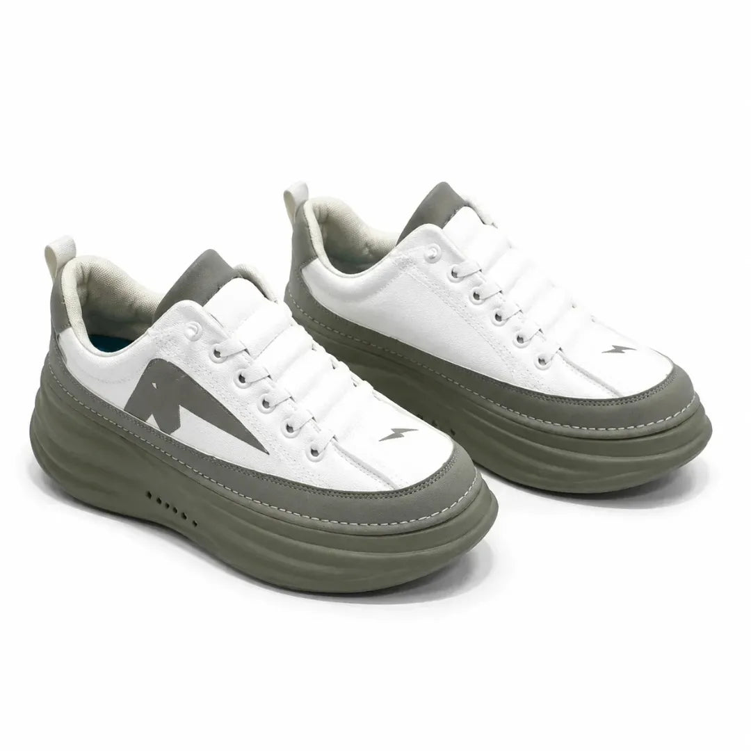 A pair of low-top platform sneakers in white and olive green, featuring a chunky sole, white laces, and a stylized dark green chevron logo on the side.