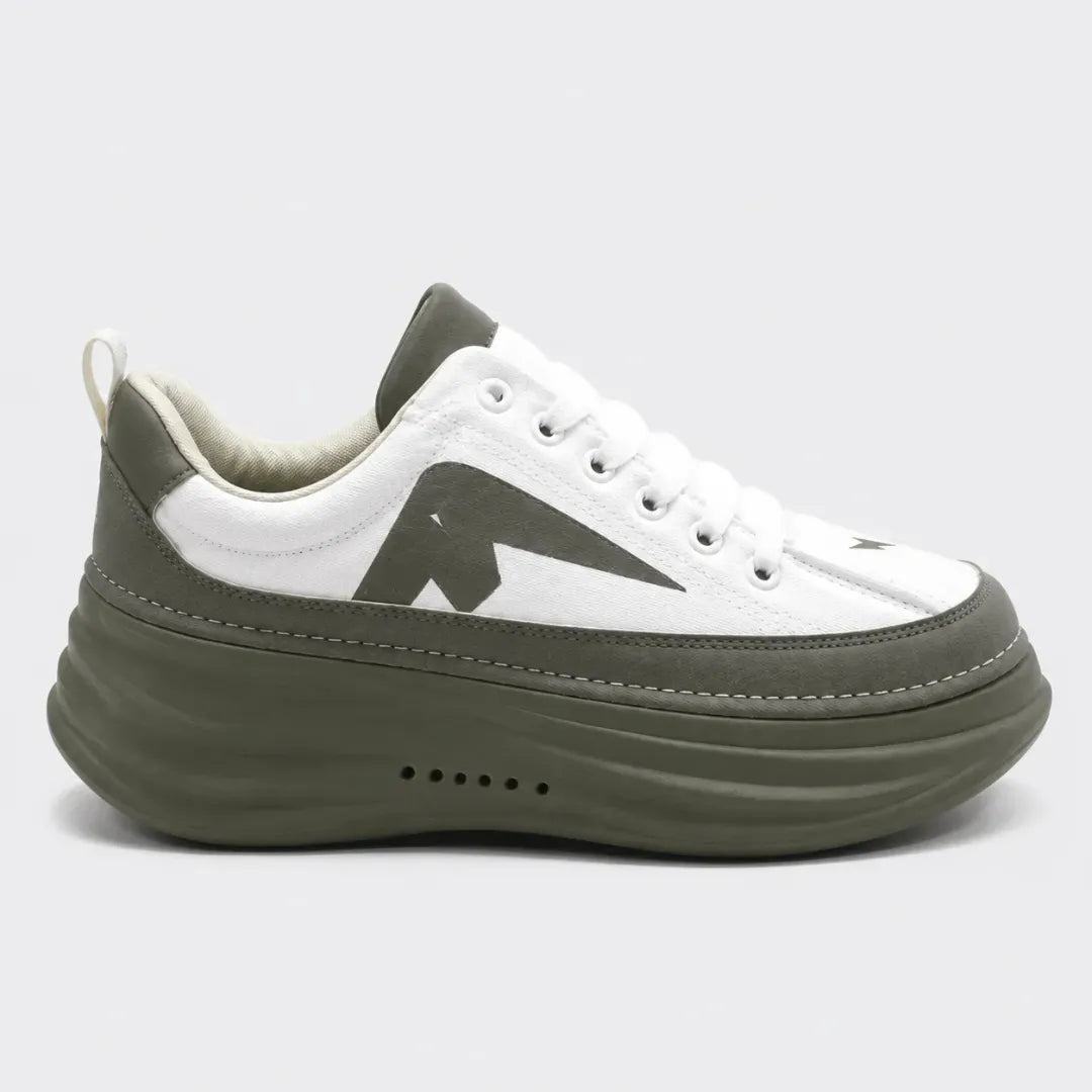 A low-top platform sneaker in white and olive green, featuring a chunky olive green sole, white laces, and a large dark green geometric side logo, shown against a light gray background.