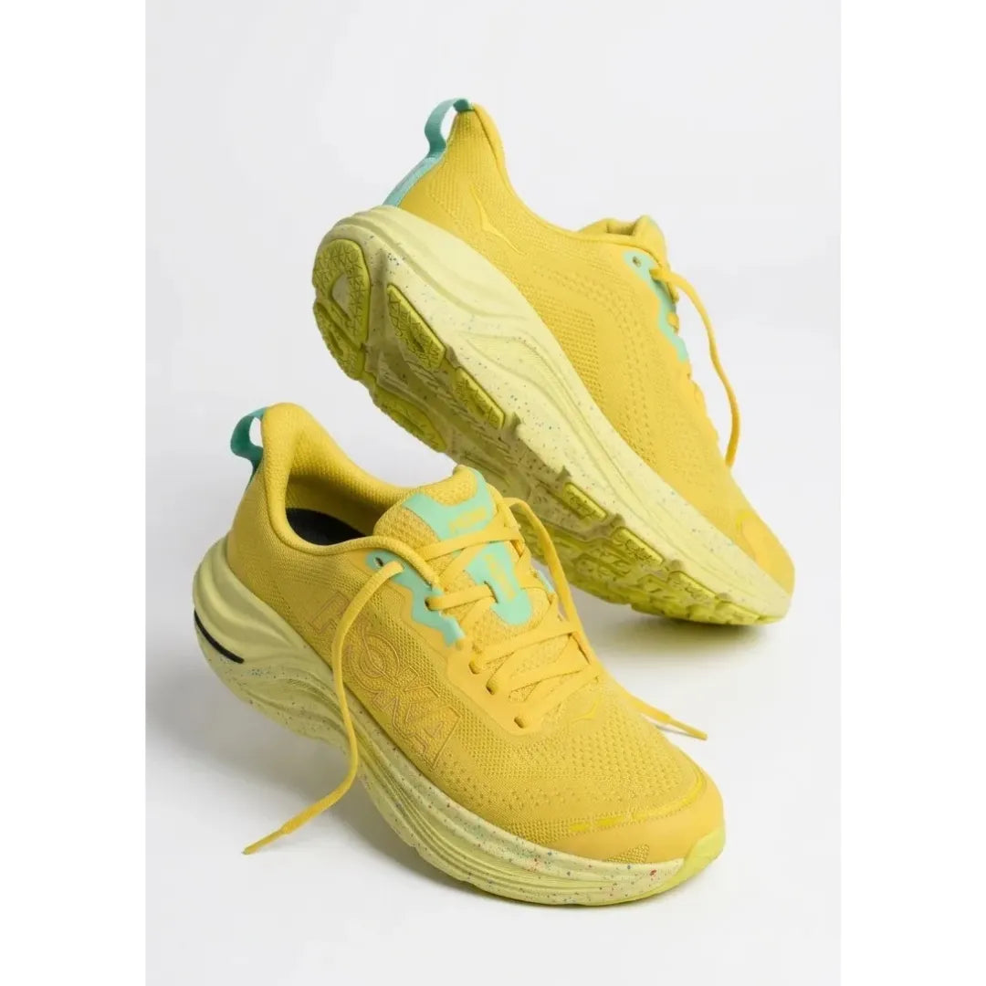 A pair of On running shoes in light gray, featuring a breathable mesh upper, matching gray laces, a thick cushioned sole with circular cutouts, and the On logo on the side, set against a plain white background.