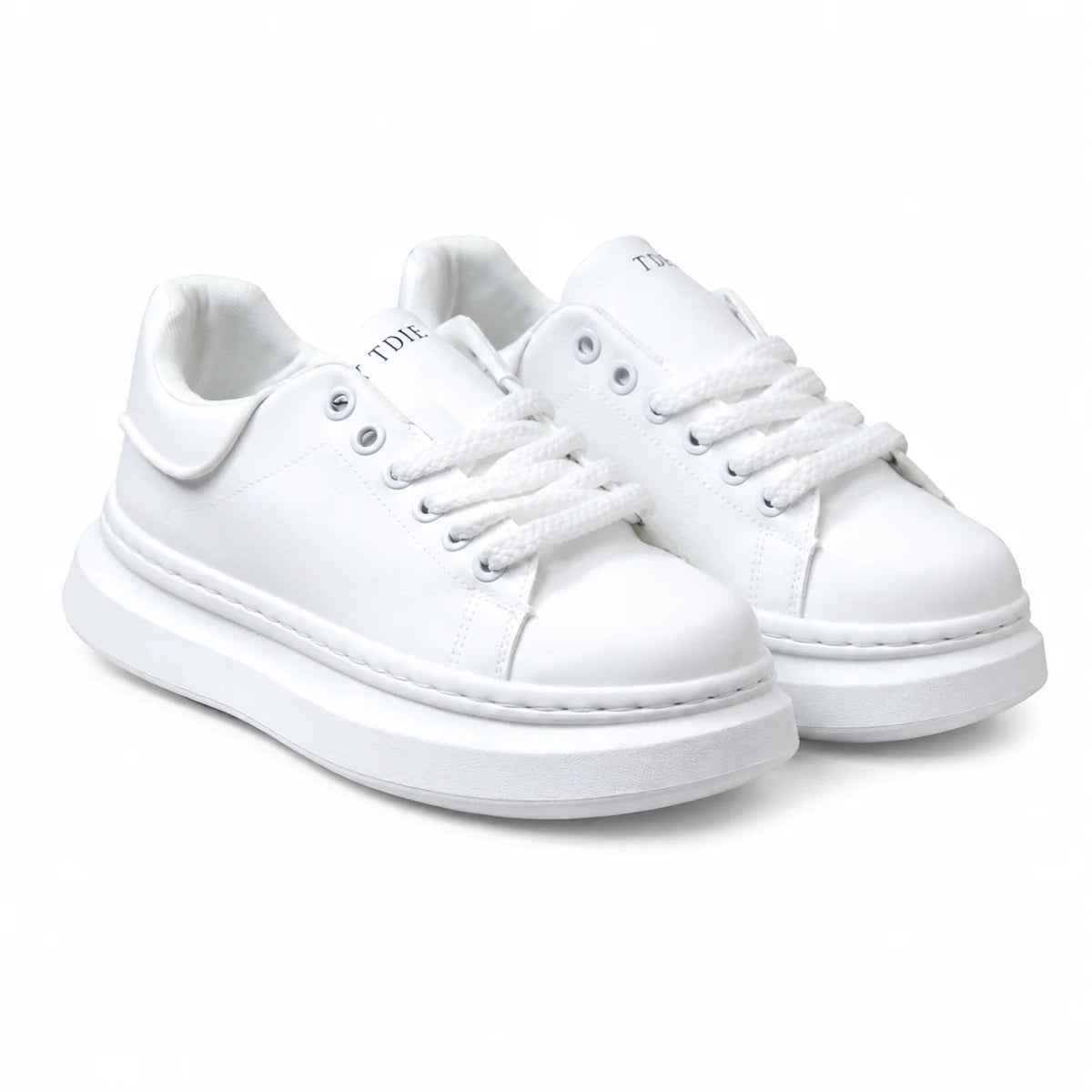 A pair of white low-top platform sneakers with matching white laces and thick white soles, shown on a clean white background.