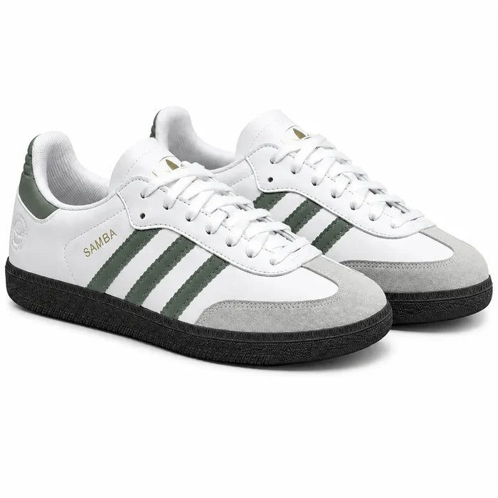 White Adidas Samba sneakers with green three stripe detailing