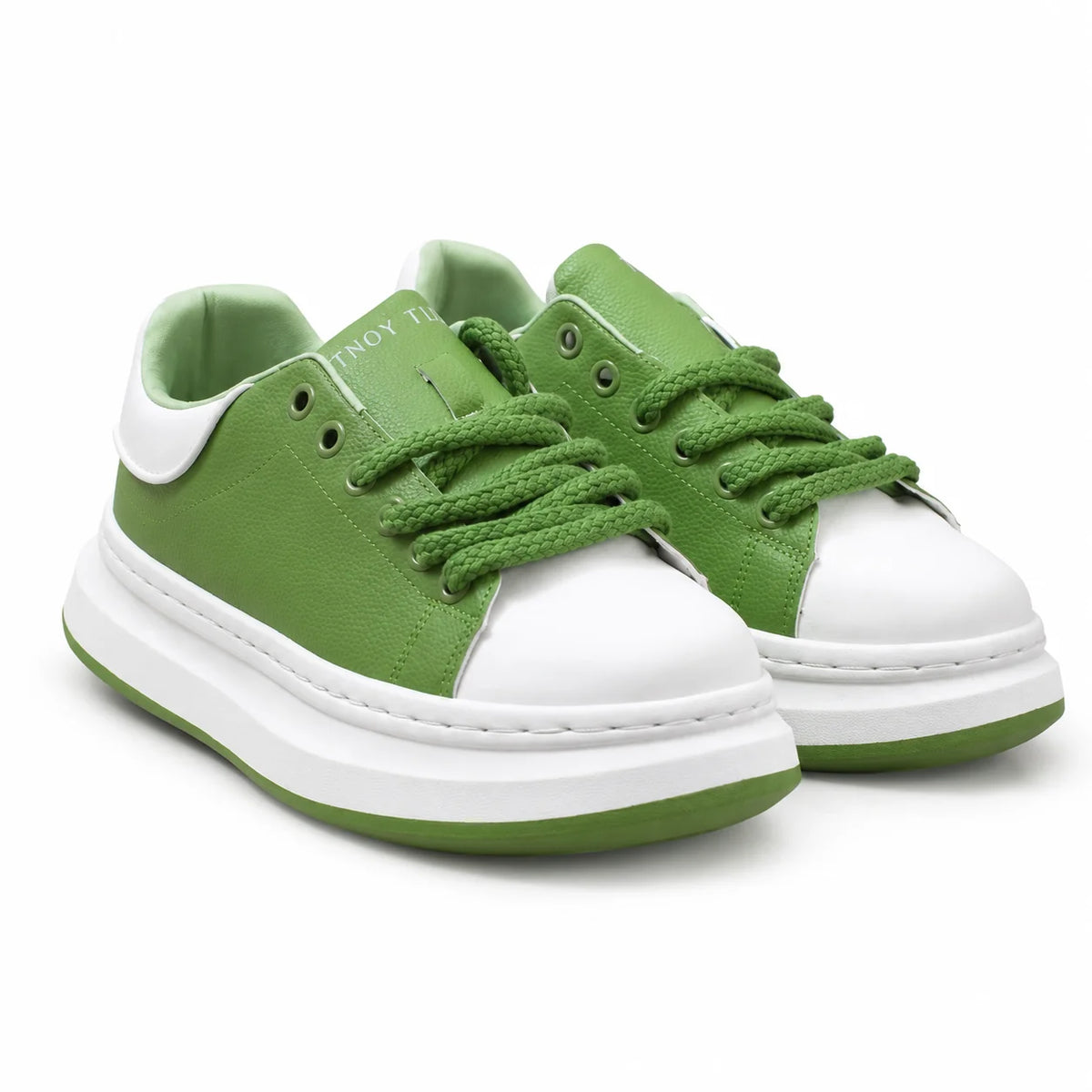 A pair of low-top platform sneakers in green and white, featuring green laces, a green outsole, and a thick white platform sole, shown on a clean white background.