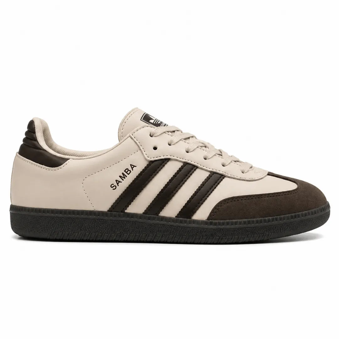 A low-top Adidas Samba sneaker in beige and dark brown, featuring three black stripes on the side, a beige leather upper, a dark brown suede toe cap, and a black rubber sole.
