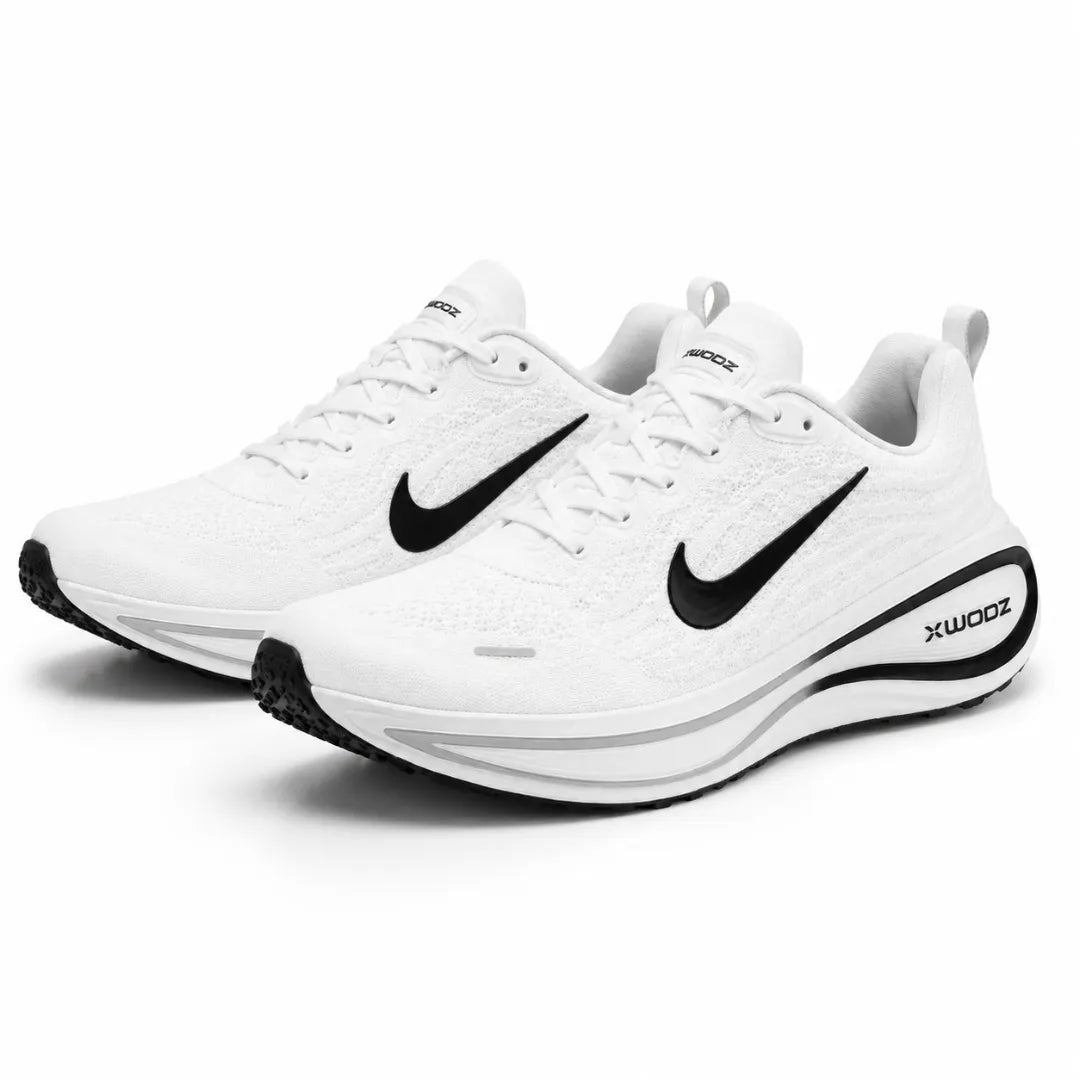 A pair of Nike running shoes in white with black accents, including the Swoosh logo and X-WOODZ branding on the heel, set against a plain white background.