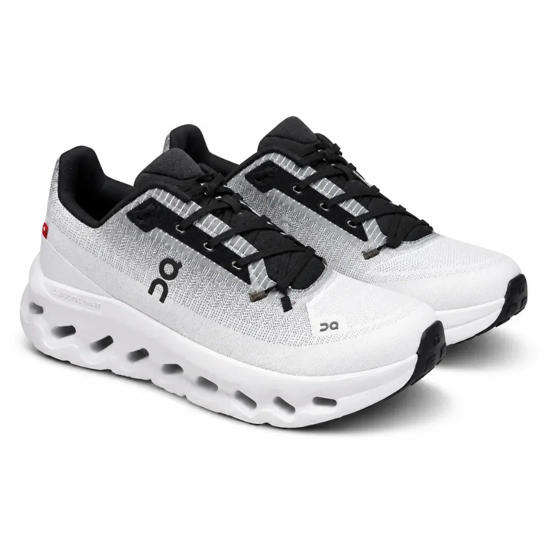 A pair of On running shoes in white and black, featuring a breathable mesh upper, black laces, and a chunky white cushioned sole with cutout details, shown on a white background.