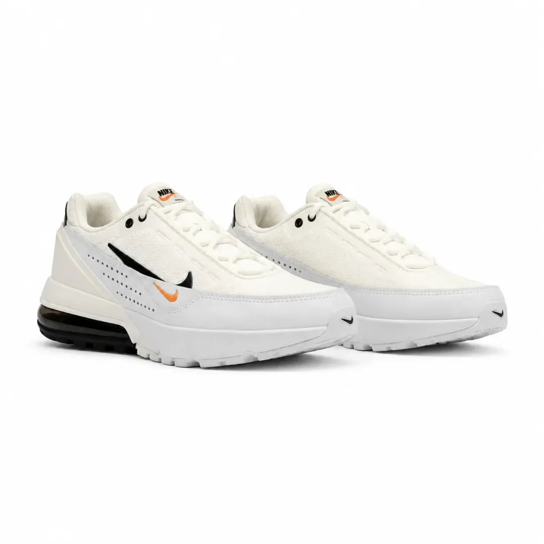 A pair of Nike sneakers in white, featuring a black Swoosh with a small orange accent, a black heel air unit, and white laces, set against a plain white background.