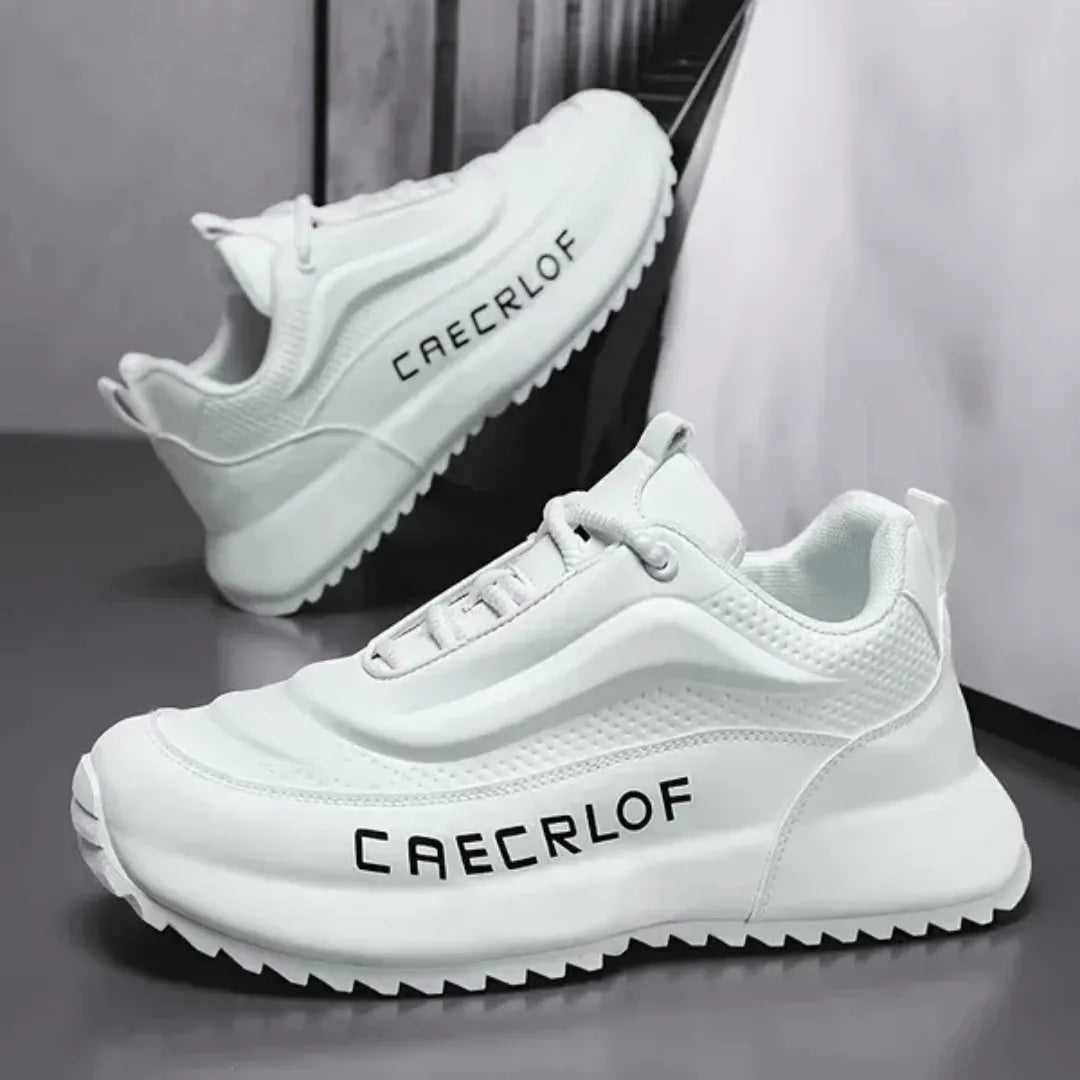 White sneakers with 'CAECLLOF' branding on a gray surface.