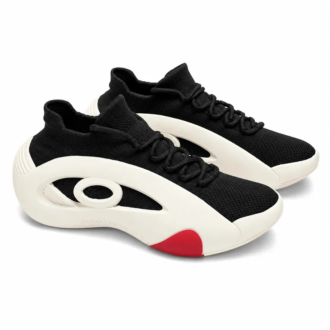 A pair of black and off-white athletic sneakers with a distinctive circular cutout design on the side and a red accent on the heel, shown on a white background.