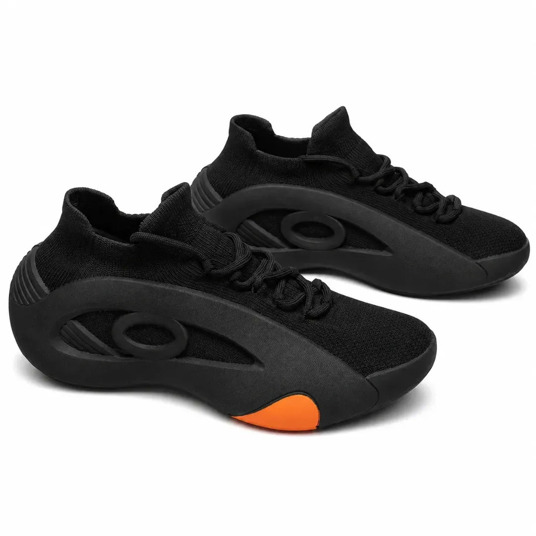 A pair of black knit athletic sneakers with a distinctive sculpted sole and a bright orange accent on the toe, shown against a plain white background.