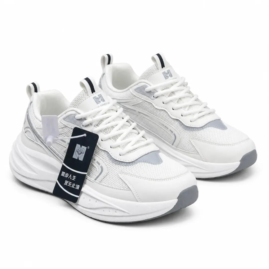 A pair of white and light gray chunky sneakers with white laces, a thick white sole, and a black hangtag attached to the front shoe, shown on a clean white background.