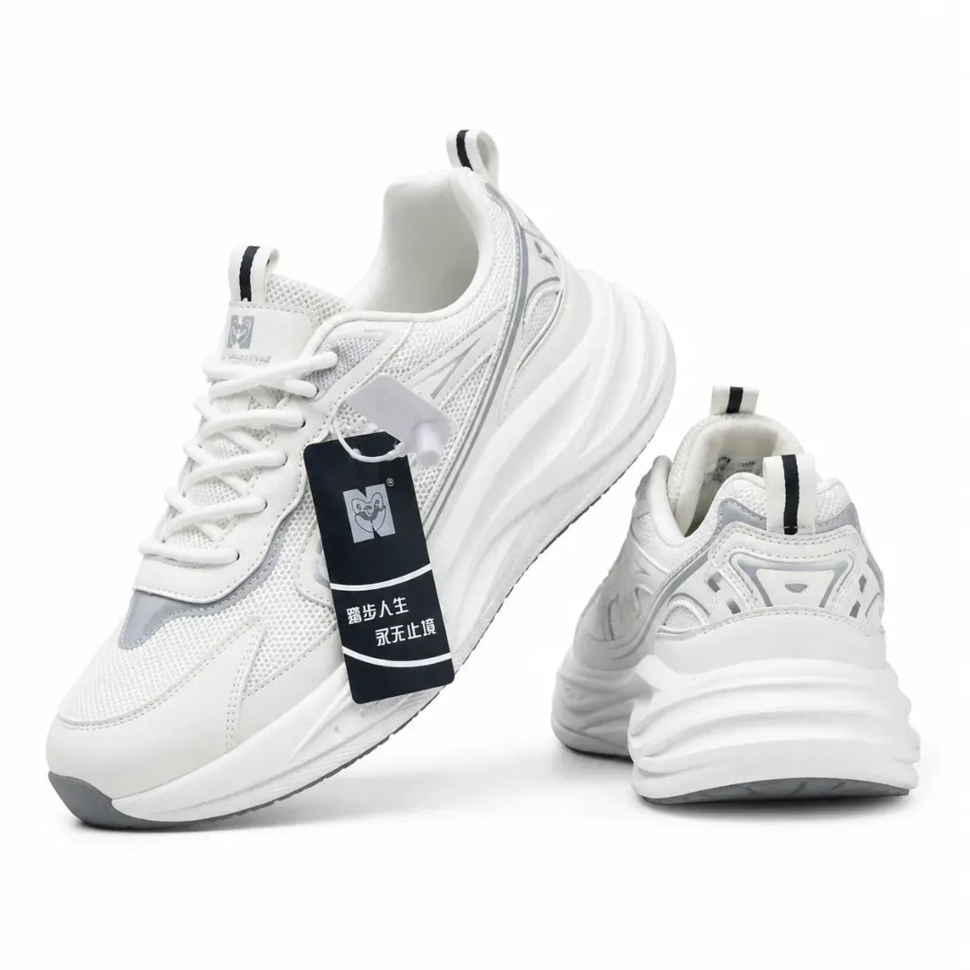 A pair of chunky white sneakers with gray and black accents, featuring a thick sculpted sole, mesh panels, and a black hangtag with Chinese text.