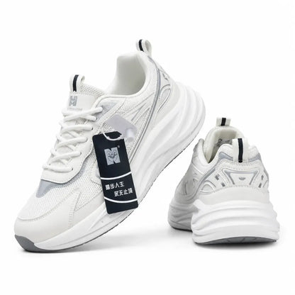 A pair of chunky white sneakers with gray and black accents, featuring a thick sculpted sole, mesh panels, and a black hangtag with Chinese text.
