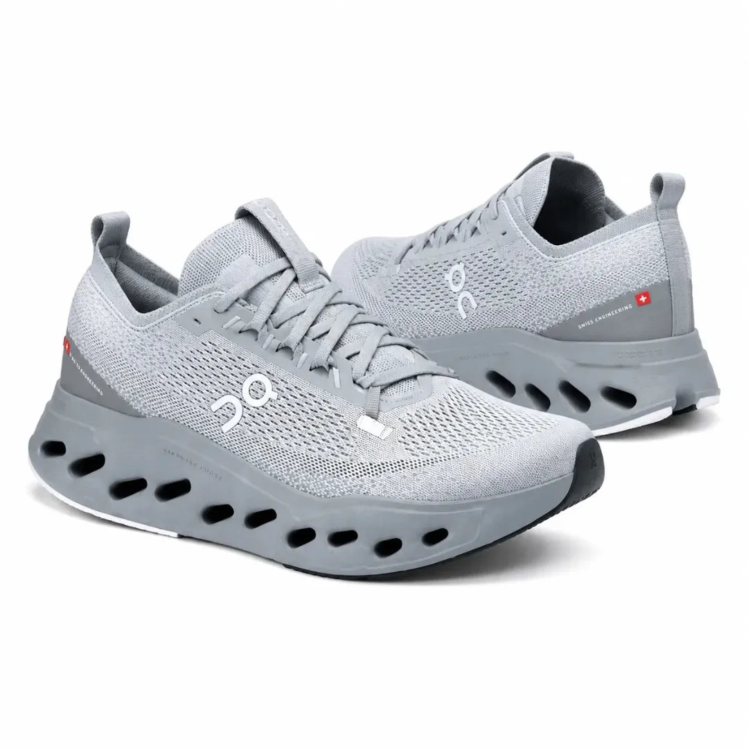 A pair of light gray On running shoes with a breathable mesh upper, thick cushioned sole, and visible On logo on the side, photographed on a clean white background.