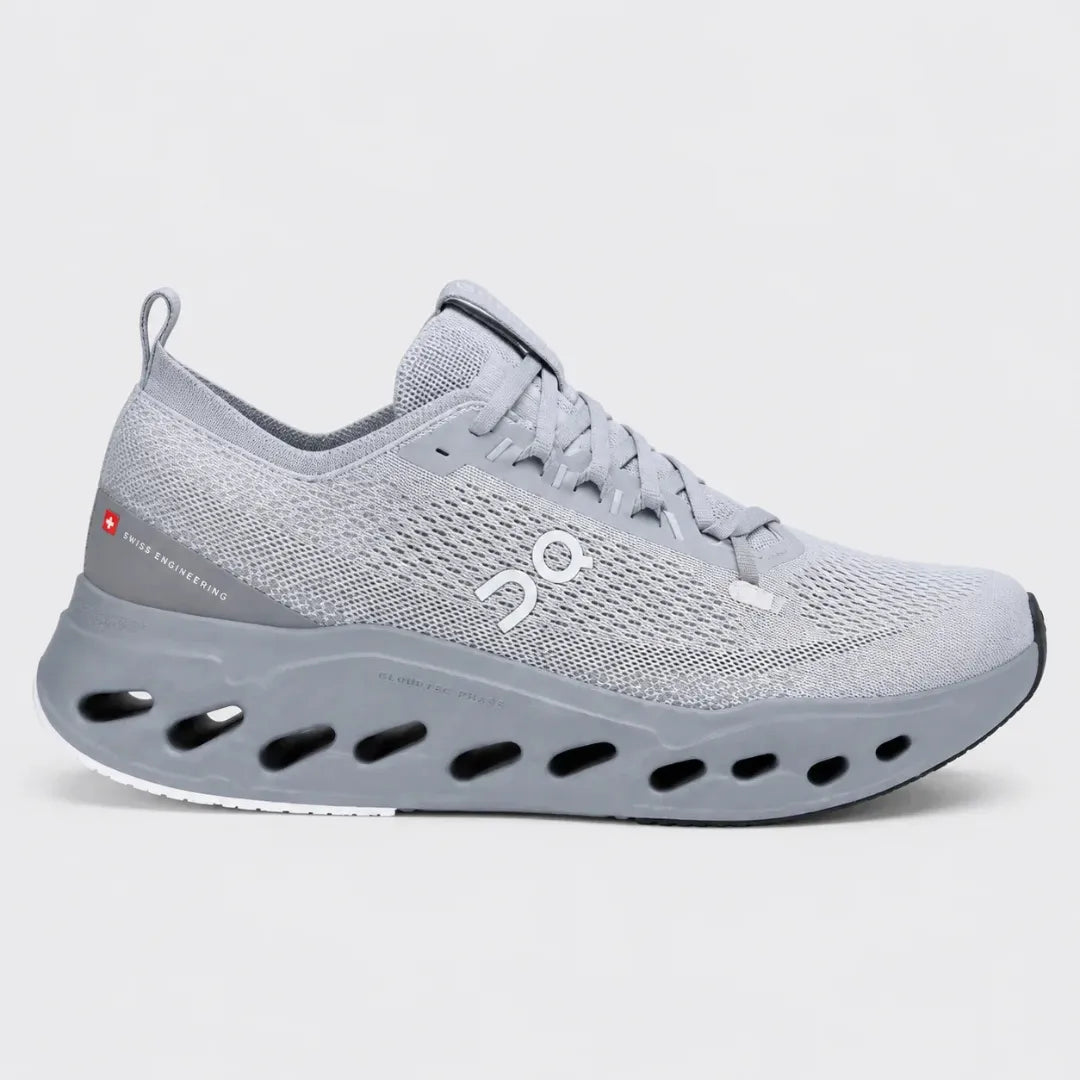 A light gray On running shoe with a distinctive sculpted sole featuring circular cutouts, shown in a side profile against a light gray background.