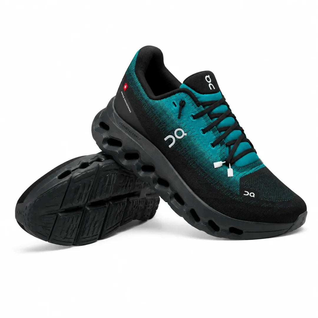 A pair of On running shoes in black and teal, with one shoe standing upright and the other lying on its side to show the sole, on a white background.