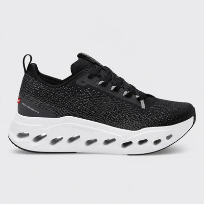 Black and green running shoe with white sole on a white background