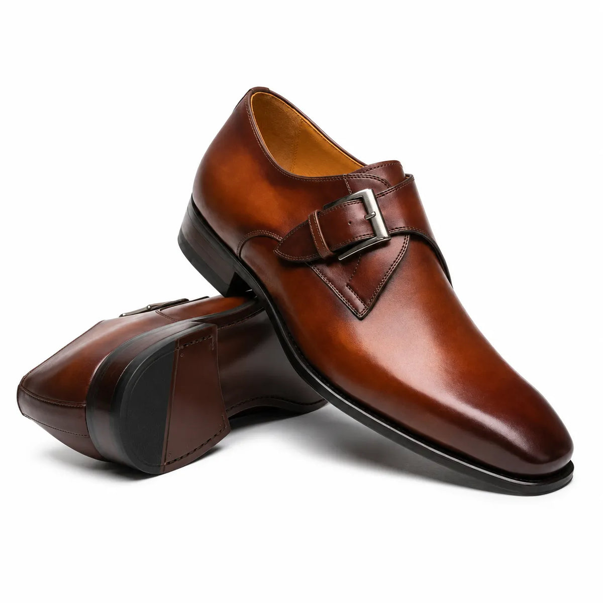 Premium men's brown leather dress shoes featuring a single monk strap buckle and sleek pointed toe design.