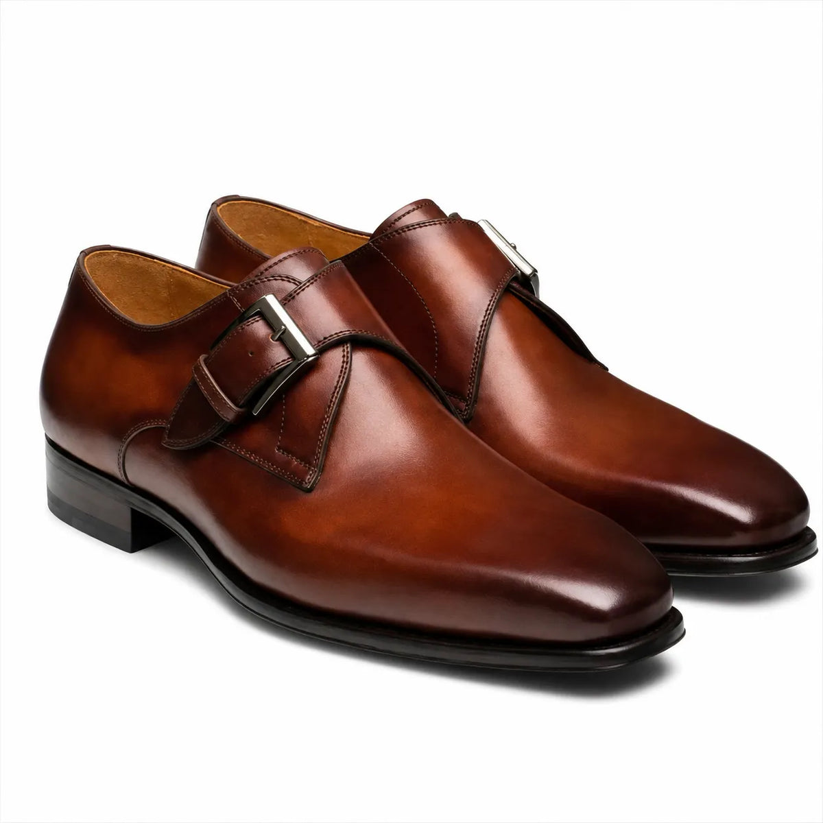 Premium men's brown leather dress shoes featuring a single monk strap buckle and sleek pointed toe design.