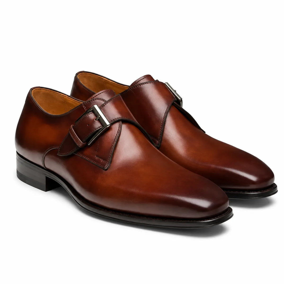 A pair of men's double monk strap leather shoes in a rich cognac brown,