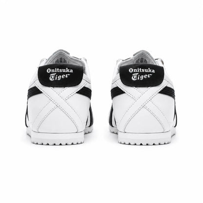 A pair of white and black Onitsuka Tiger sneakers shown from the back, featuring the brand name in white gothic lettering on black heel tabs.