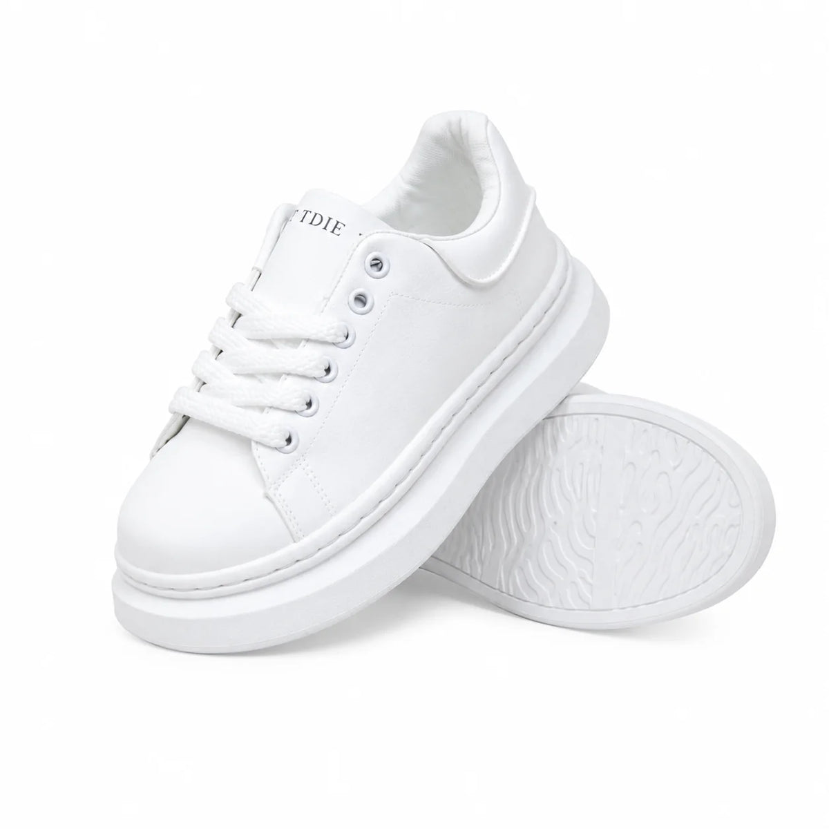 A pair of white platform sneakers with white laces and thick white soles, displayed on a clean white background.