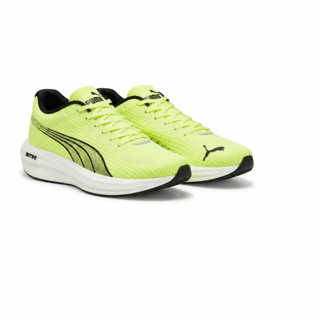 A pair of Puma running shoes in a vibrant neon yellow-green, featuring black Puma Formstripes on the side, a black Puma cat logo on the toe box, and a white Nitro midsole, set against a plain white background.
