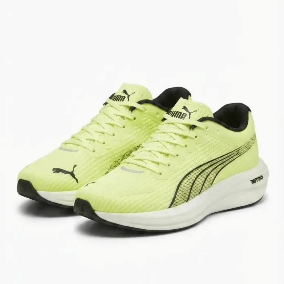 A pair of Puma running shoes in a vibrant neon yellow-green colorway, featuring black Puma cat logos and the Formstrip design on a clean white background.
