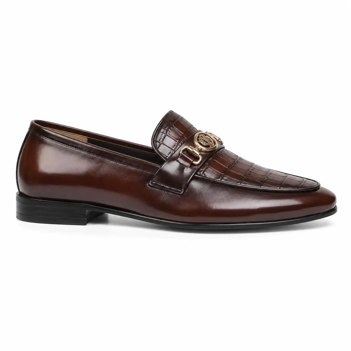 A single brown leather loafer with a crocodile-embossed toe cap, a strap with a gold-tone decorative buckle, and a low black heel