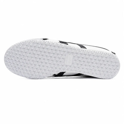 The white textured outsole of a black and white sneaker, viewed from underneath against a plain white background.